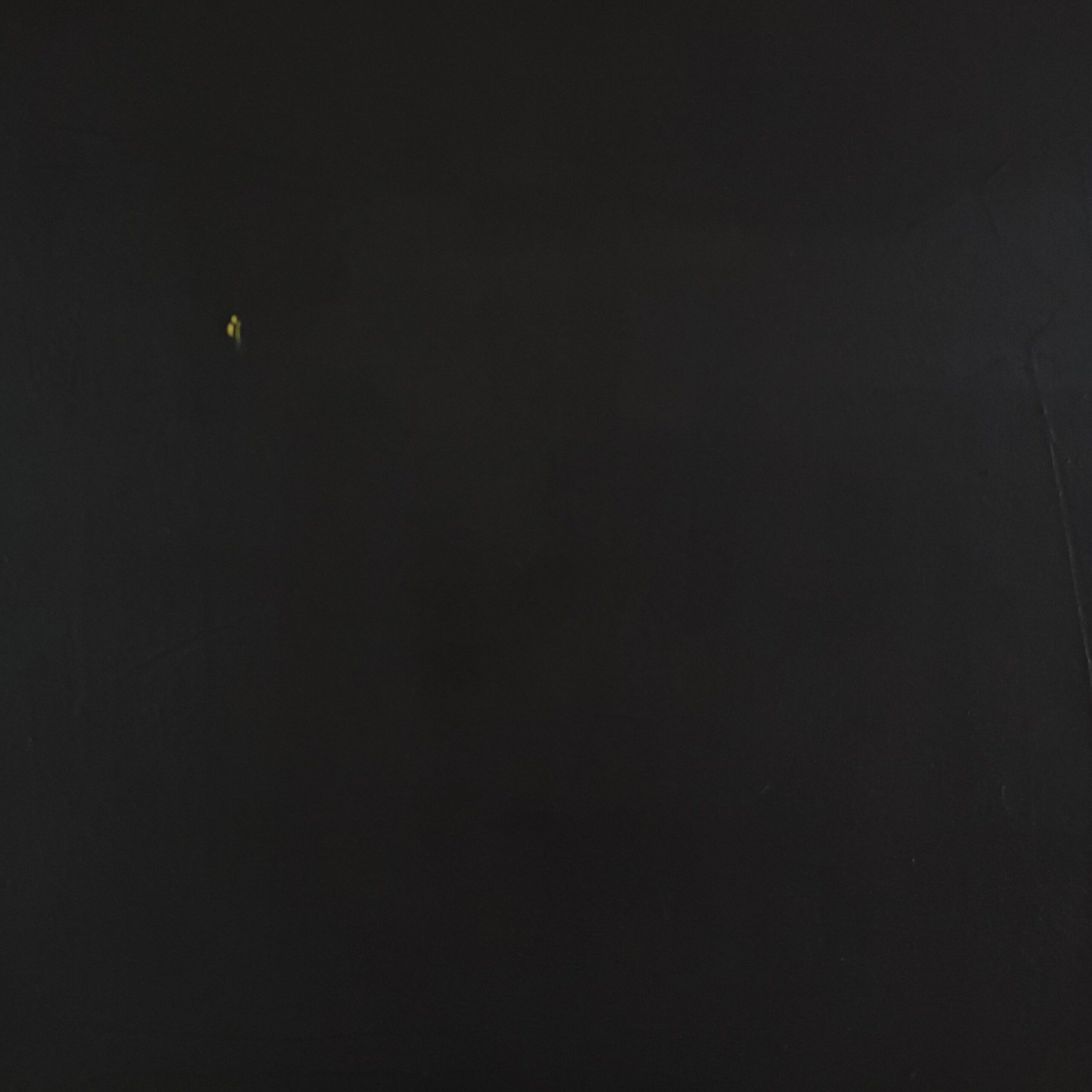 Blackout in Berlin by Ricarda Simon (2026). A dim, expansive urban landscape of Berlin lies in deep shadow, emphasizing the fragility of complex modern infrastructure. In the vast darkness, a single candle flickers, representing hope and resilience anchored in established values.